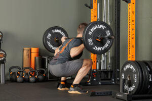 Squatting with a Mirafit Olympic Olympic Rubber Bumper Plate Set