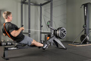 athlete using Mirafit Rowing Machine in a home gym