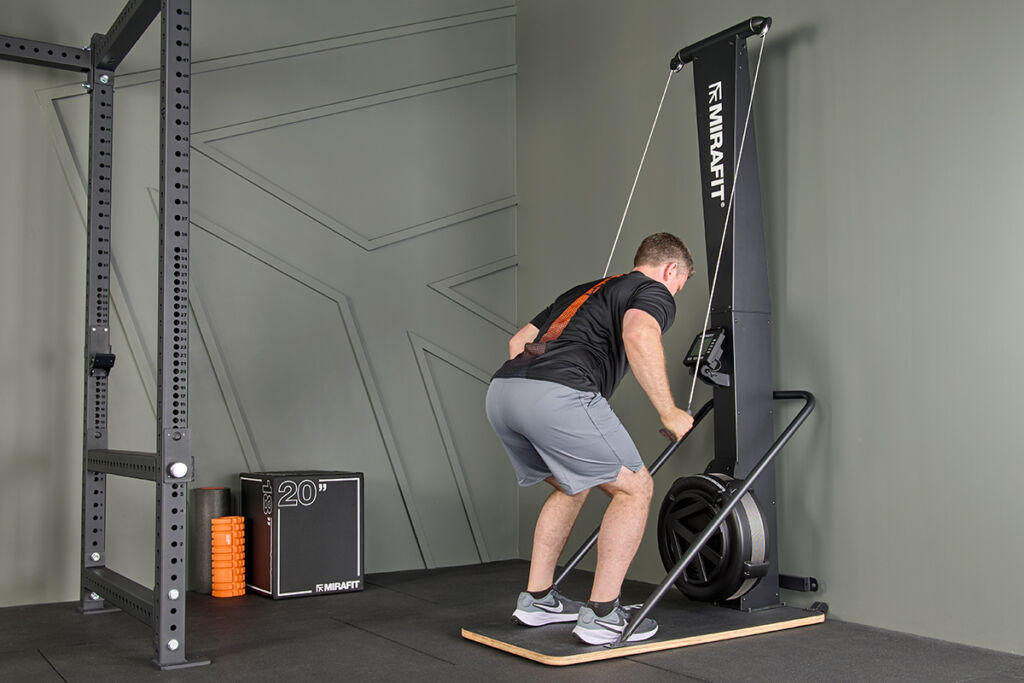 athlete using a Mirafit Ski Machine in a home gym
