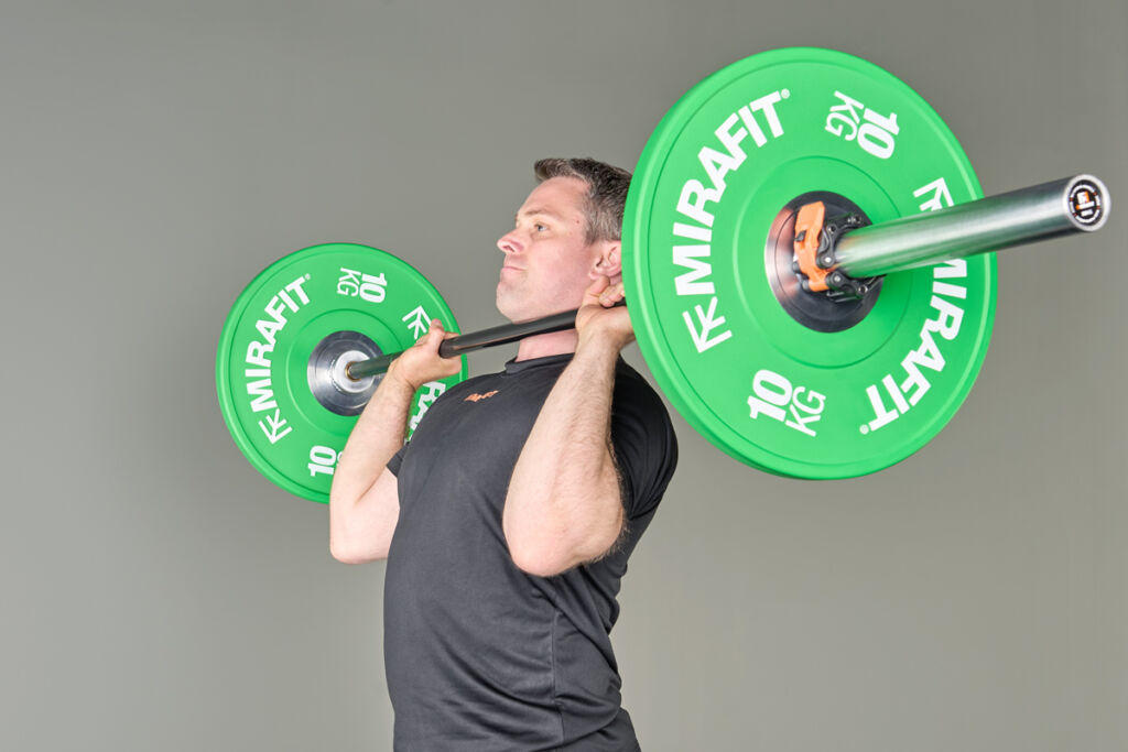 Mirafit Narrow Coloured Olympic Bumper Plates Barbell push press using Mirafit Bumper Plates