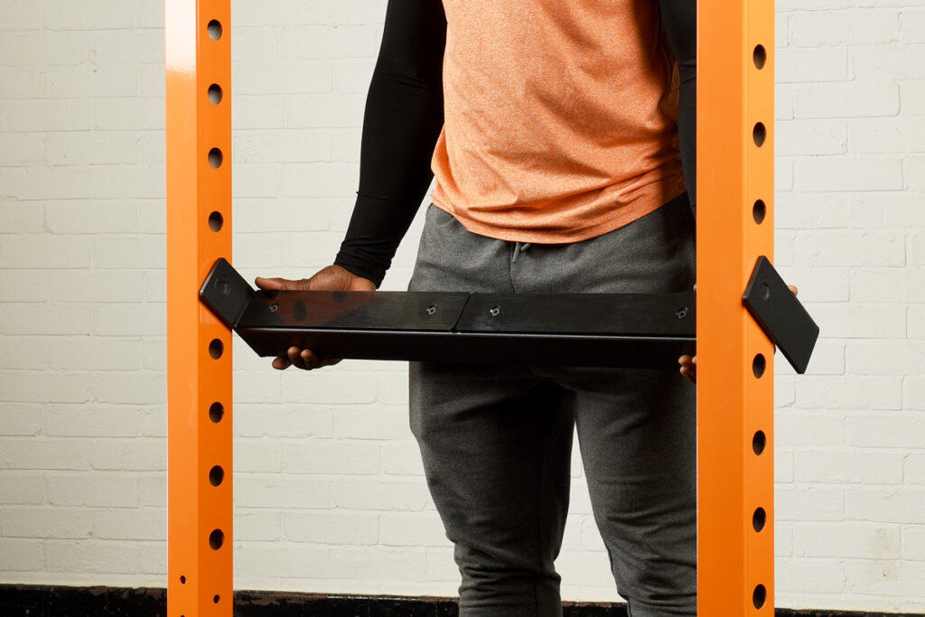 Mirafit M2 Black 60mm Safety Spotters Man installing Mirafit M200 Power Rack safety spotters