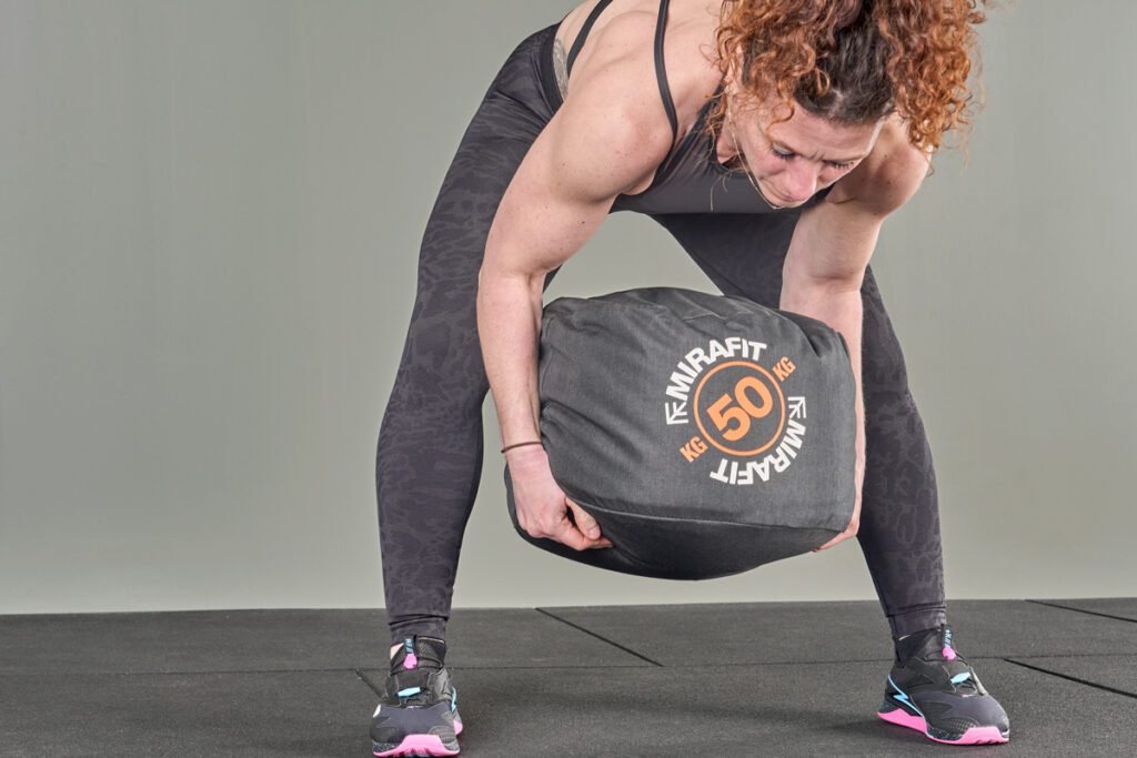 lifting a Mirafit 50kg sandbag