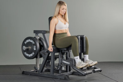 woman using a Mirafit Hip Abductor and Adductor Machine