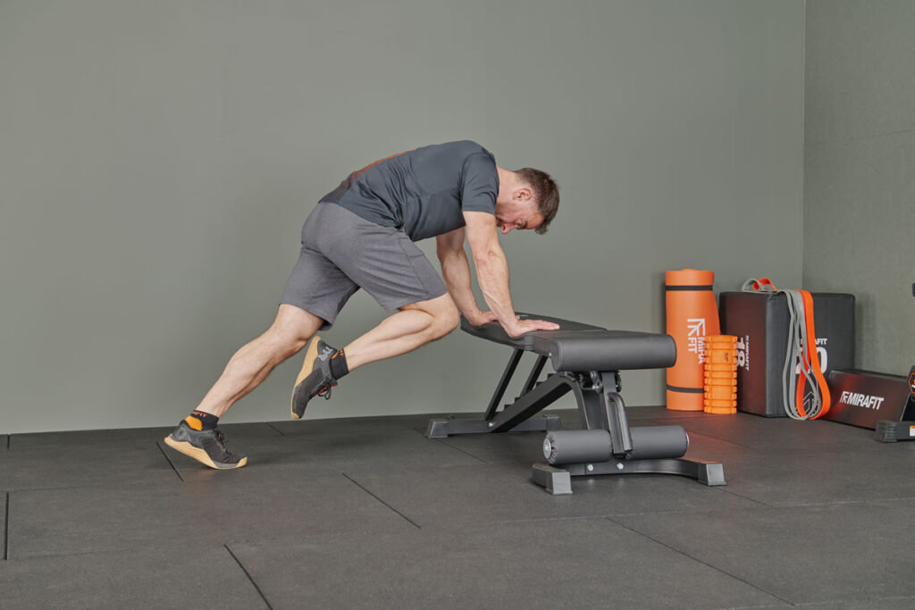 Incline mountain climbers on a Mirafit M160 FID Adjustable Weight Bench