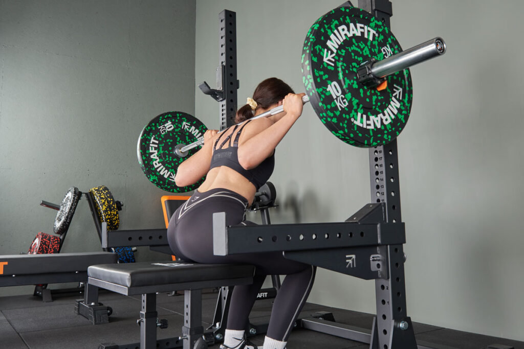 Box squat using a Mirafit M3 20kg Olympic Barbell