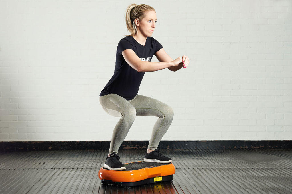 Mirafit Slimline Vibration Plate Woman doing a squat on a Mirafit Slimline Vibration Plate