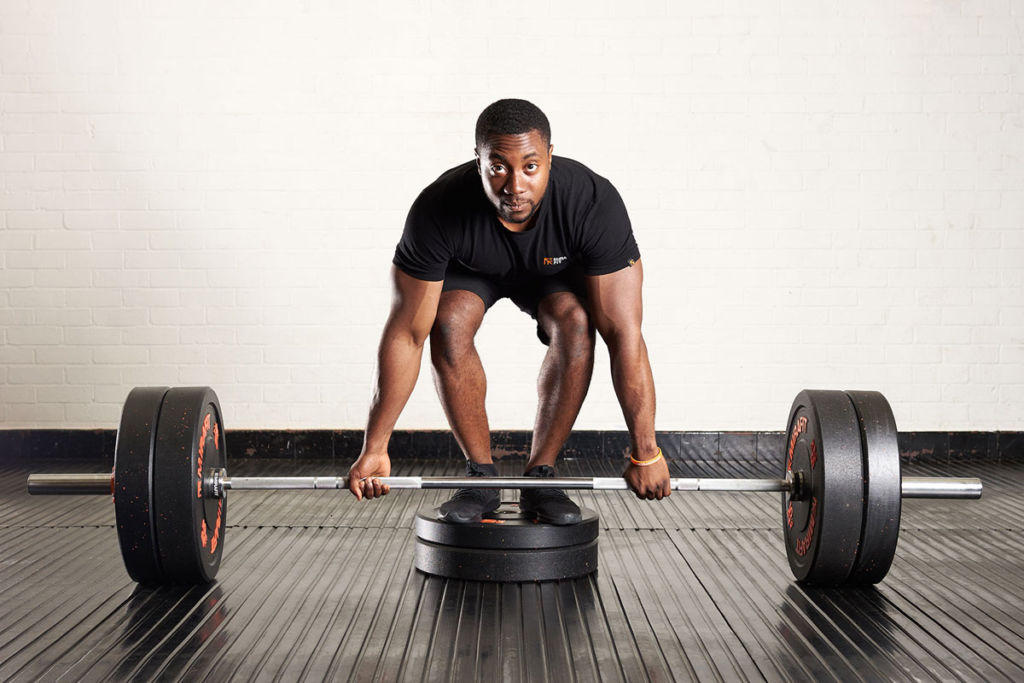 Deficit deadlift Man doing a deficit deadlift with Mirafit weight plates