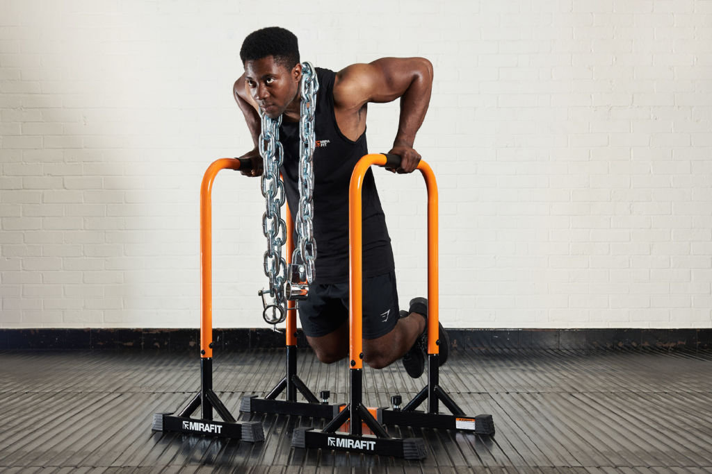 Mirafit Tall Parallettes with Adjustable Extension Bar Man doing parallel dips with Mirafit Tall Parallettes