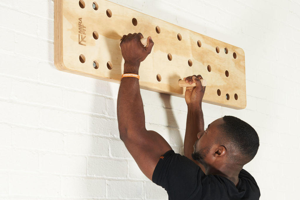 Up down fitness expert uses a Mirafit Climbing Peg Board to climb up and down