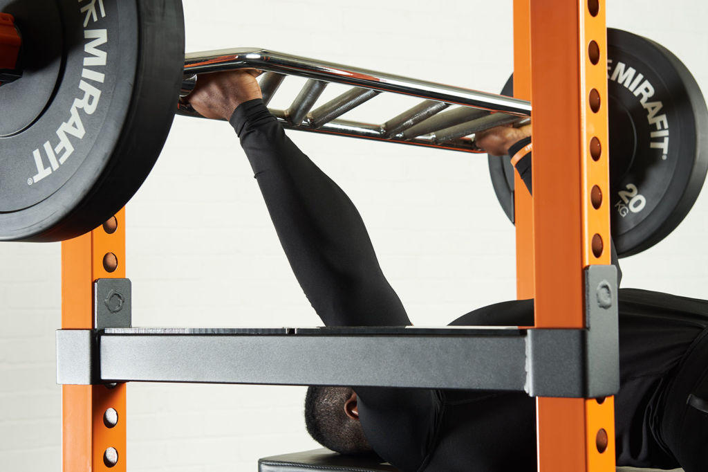 Mirafit 2" Olympic Tricep Bar Man bench pressing with a Mirafit 2" Olympic Tricep Bar & 20kg weight plates
