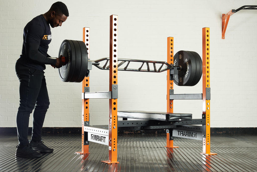 Mirafit Black Olympic Rubber Bumper Plates Man bench pressing with Mirafit bumper plates