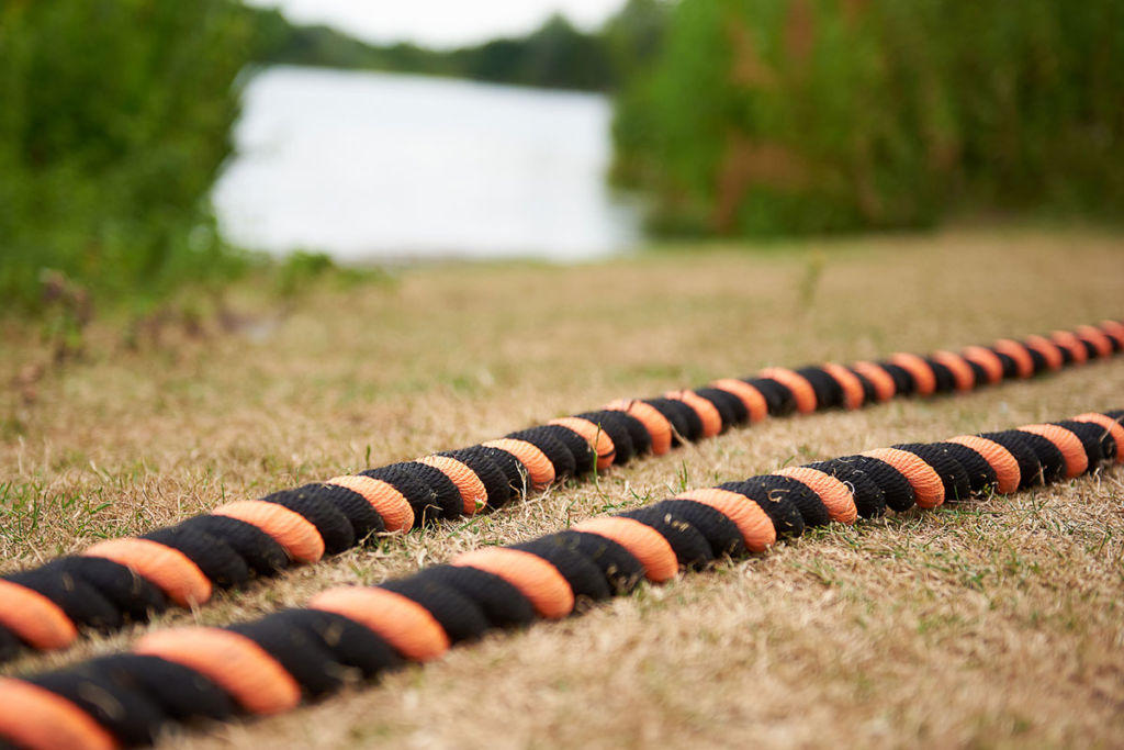 Mirafit 38mm Black & Orange Battle Ropes set up outside