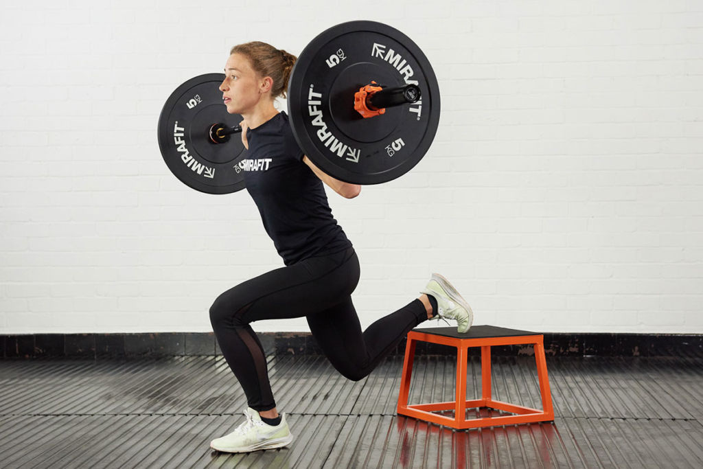 Woman doing a single leg squat using Mirafit 5kg weight plates
