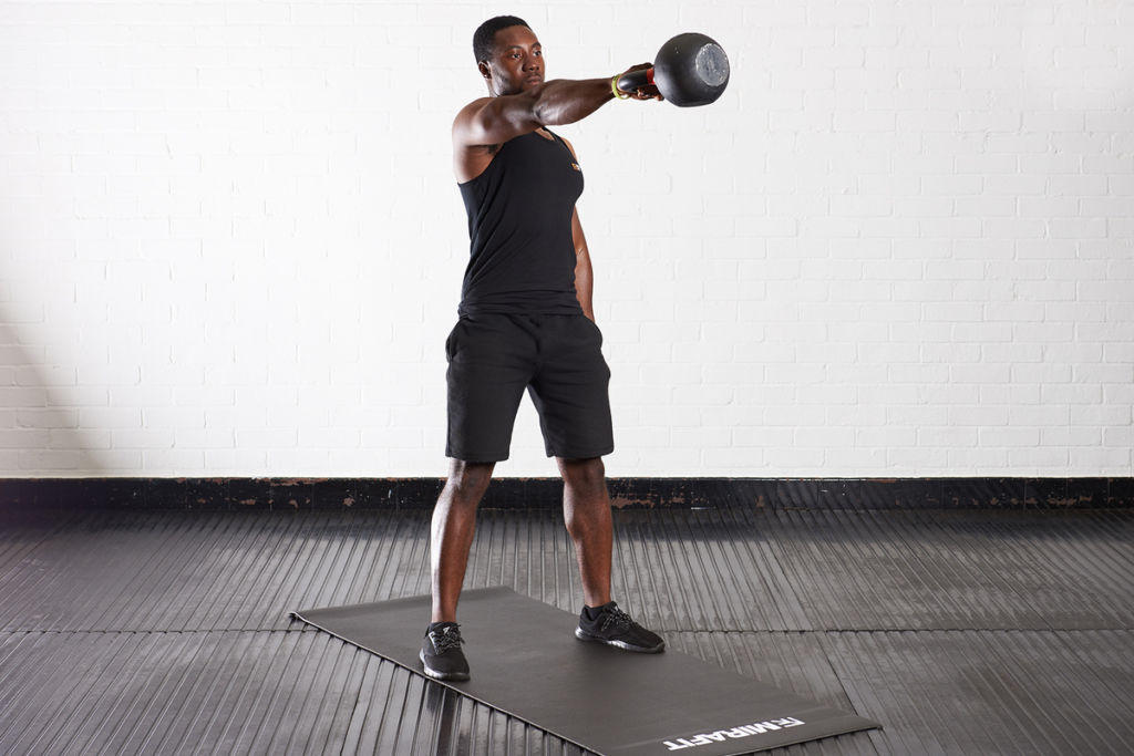 Kettlebell swing Man doing a kettlebell swing with a Mirafit Cast Iron Kettlebell