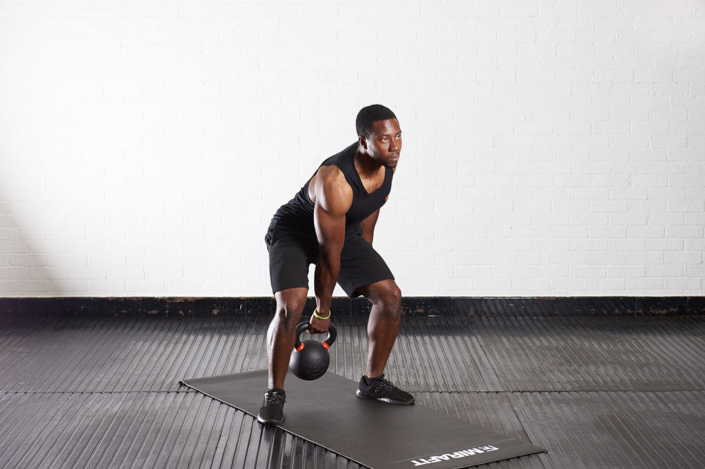 Kettlebell swing Man doing a kettlebell swing with a Mirafit Cast Iron Kettlebell