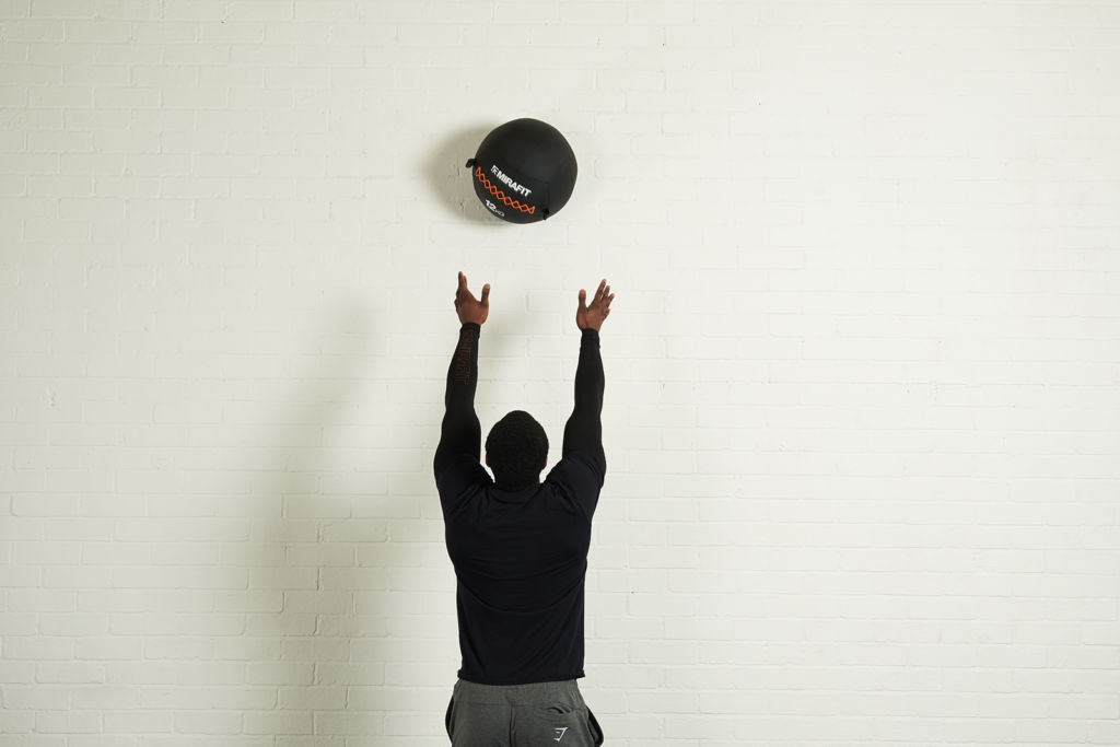 Wall ball throw Man demonstrating the Wall ball throw with a Mirafit wall ball