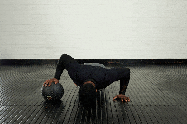 Rolling push up Man demonstrating the rolling push up with a Mirafit double handle medicine ball